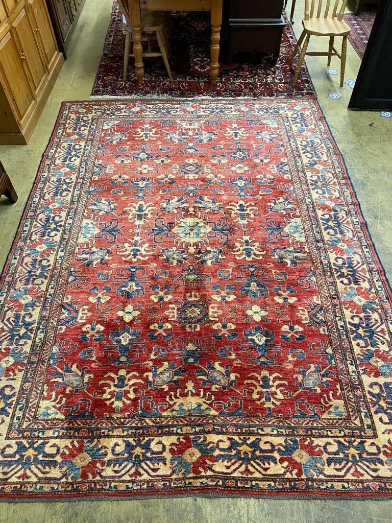 A Caucasian design red ground carpet, 310 x 224cm